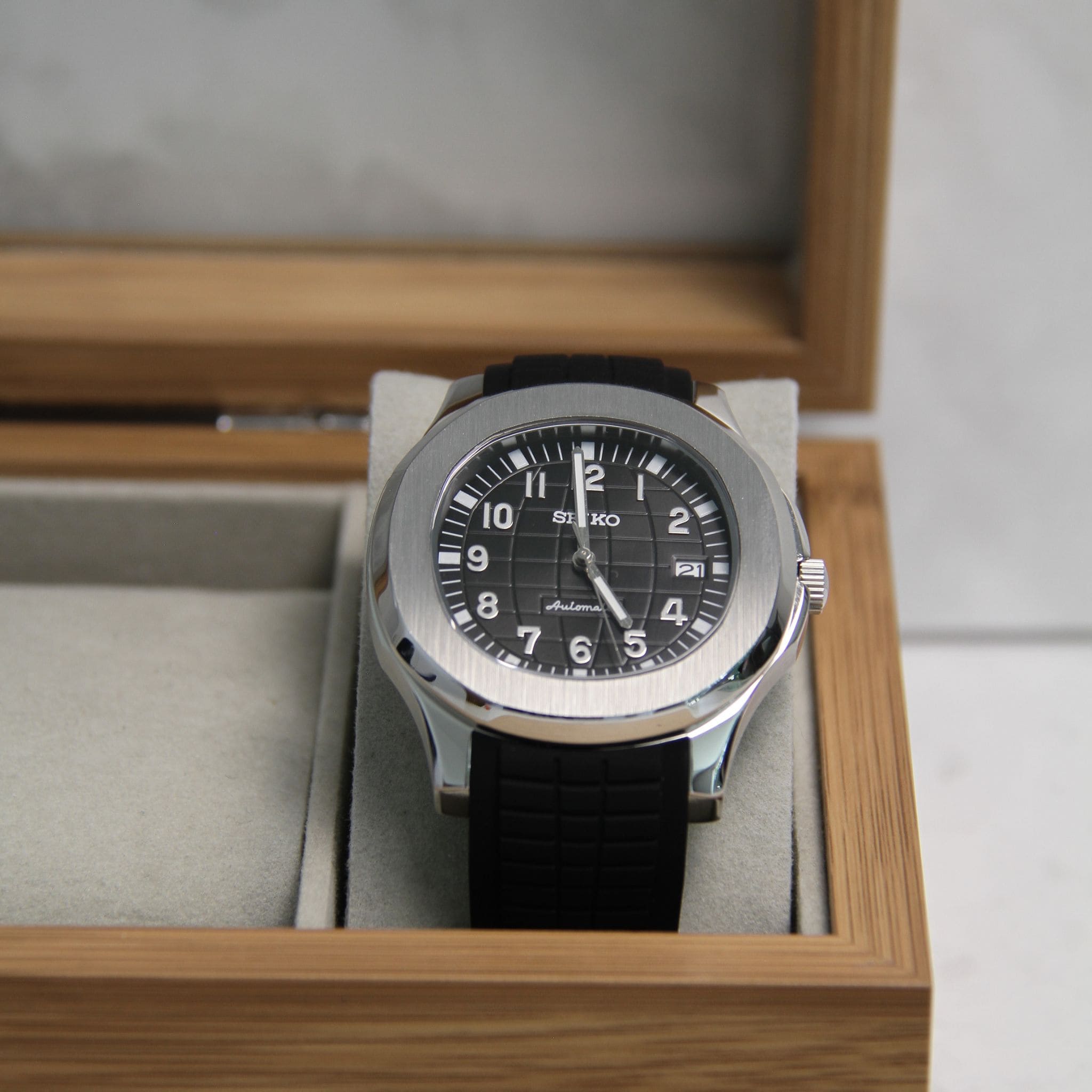 Montre Seiko mod aquanaut noir dans boite à montres.